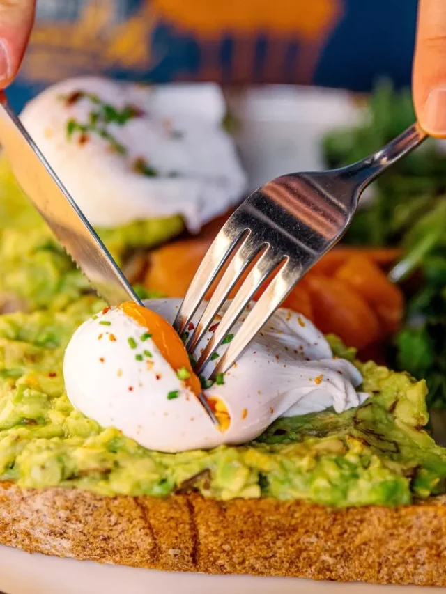 1_Man-eating-avocado-toast-with-poached-egg-and-salmon-close-up-view