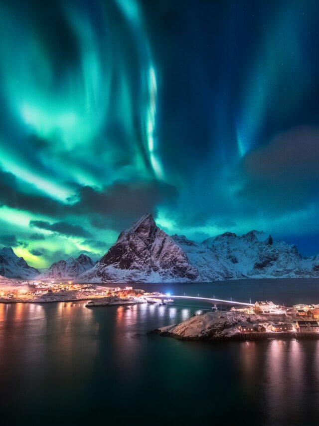 Large-Aurora-borealis-Lofoten-islands-Norway-Aurora-Green-northern-lights-Starry-sky-with-polar-lights-Night-winter-landscape-with-aurora-sea-with-sky-ref-1166906300