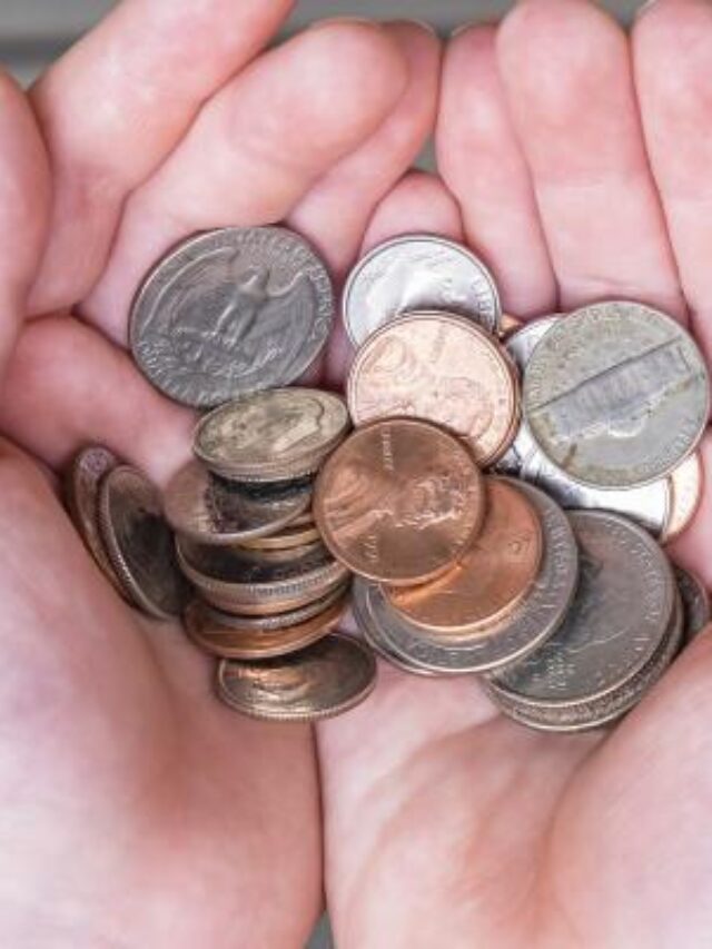 hand-holding-change-coins-penny-quarter-nickel-dime_iStock-837099894