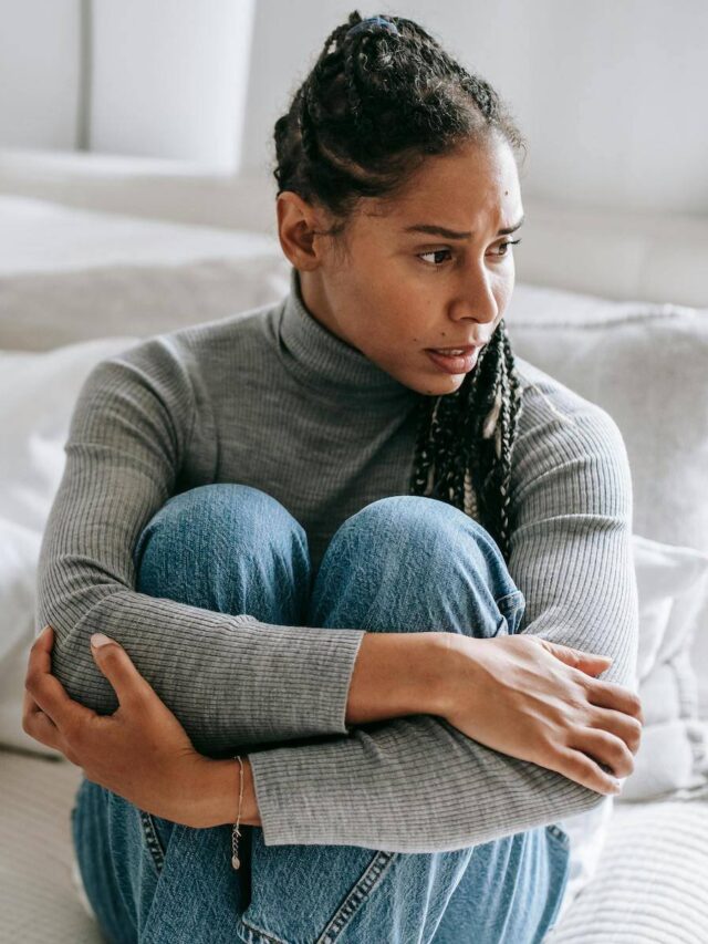 person-sitting-in-bed-dealing-with-racing-thoughts